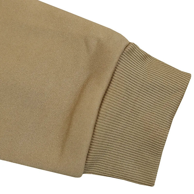 Close-up of a beige fabric with a textured pattern on a white background