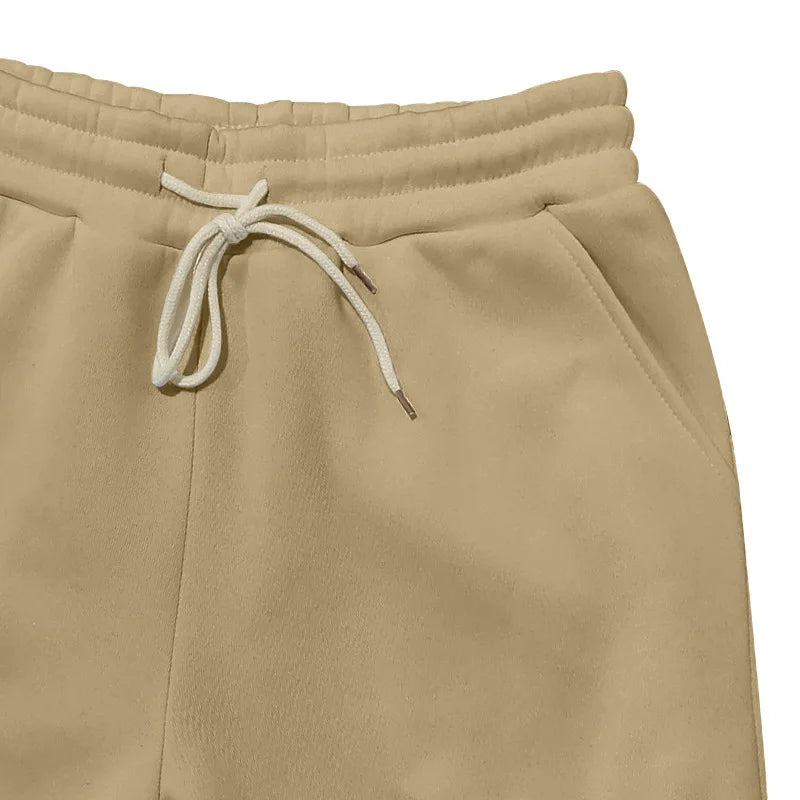 Beige sweatpants with a drawstring on a white background