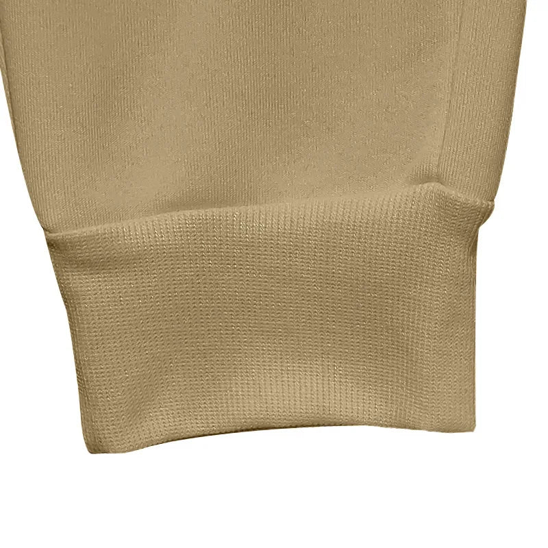Close-up of beige fabric with a textured pattern on a white background