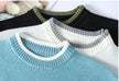 Four sweaters with different collar colors on a white background