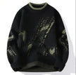 Black sweater with camouflage pattern on a white background