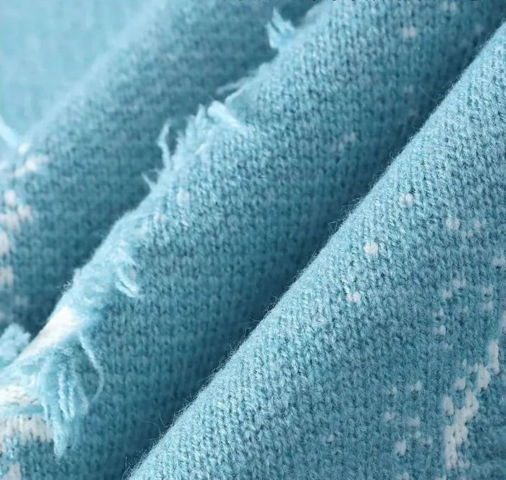 Close-up of blue fabric with visible texture and Chinese text on a light blue background