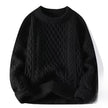Black cable knit sweater on a white background