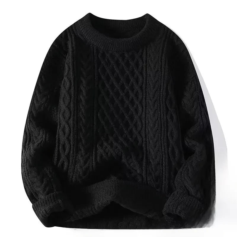 Black cable knit sweater on a white background