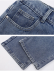 Close-up of blue denim shorts showing stitching and pocket details.