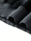 Close-up of dark gray knit fabric on a white background