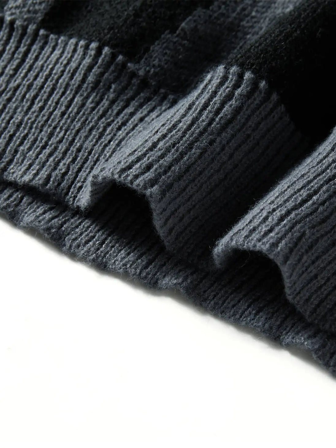 Close-up of dark gray knit fabric on a white background