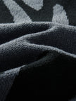 Close-up of textured dark fabric with geometric pattern