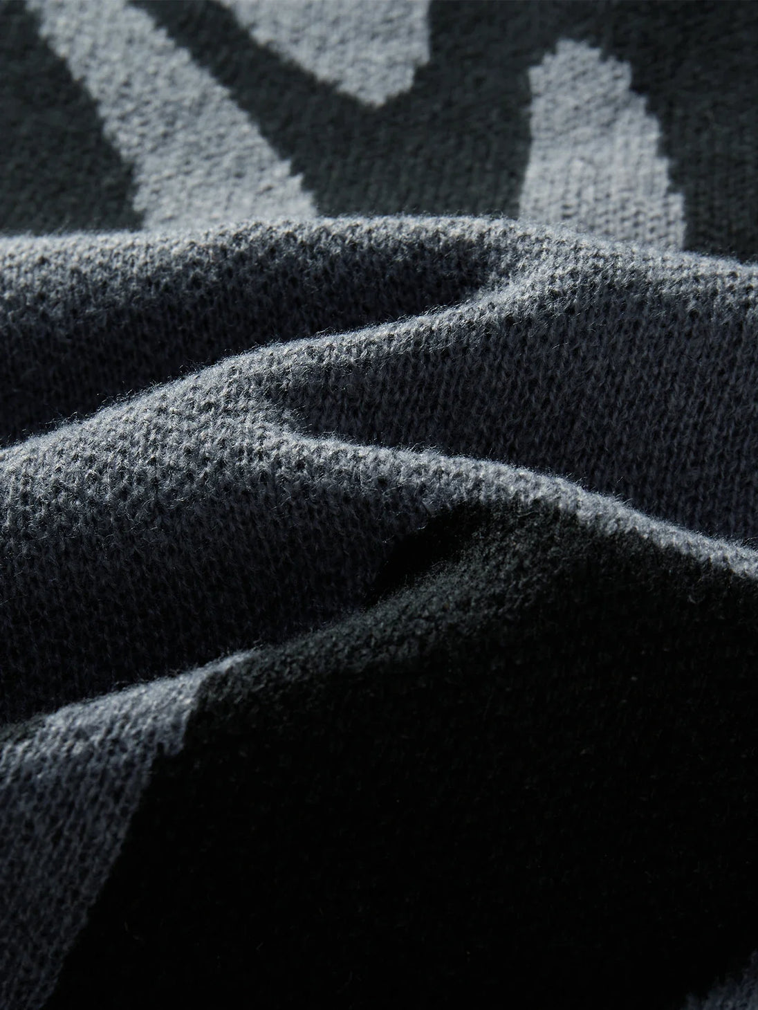 Close-up of textured dark fabric with geometric pattern