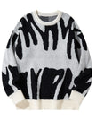 Black and white patterned sweater on a white background