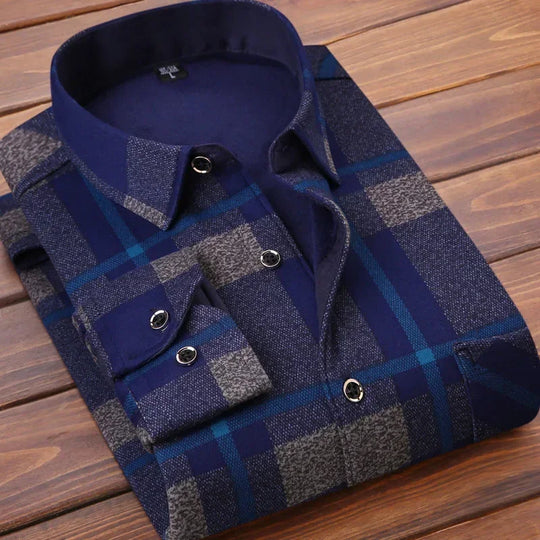 Folded blue and gray plaid shirt on a wooden surface