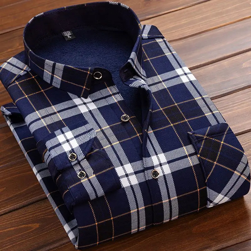 Folded navy and white plaid shirt on a wooden surface