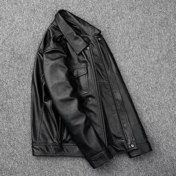 Black leather jacket on a textured gray surface