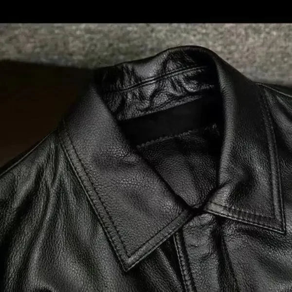 Close-up of a black leather jacket with a textured surface.