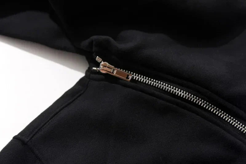 Close-up of a black jacket with a zipper on a white background