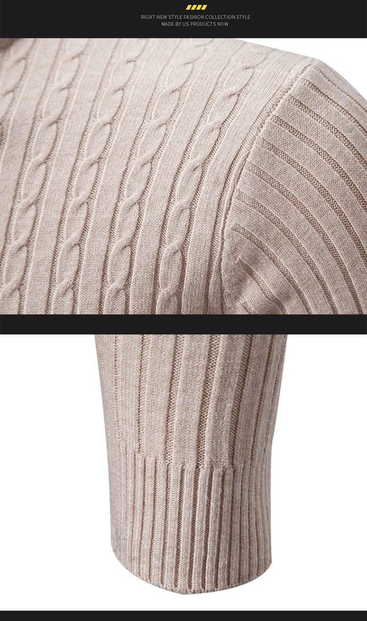 Close-up of a beige cable knit sweater sleeve with a black bar in the middle.