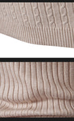 Close-up of beige textured fabric with a subtle pattern.