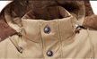 Close-up of a brown jacket collar with buttons, featuring text about material thickness and quality.