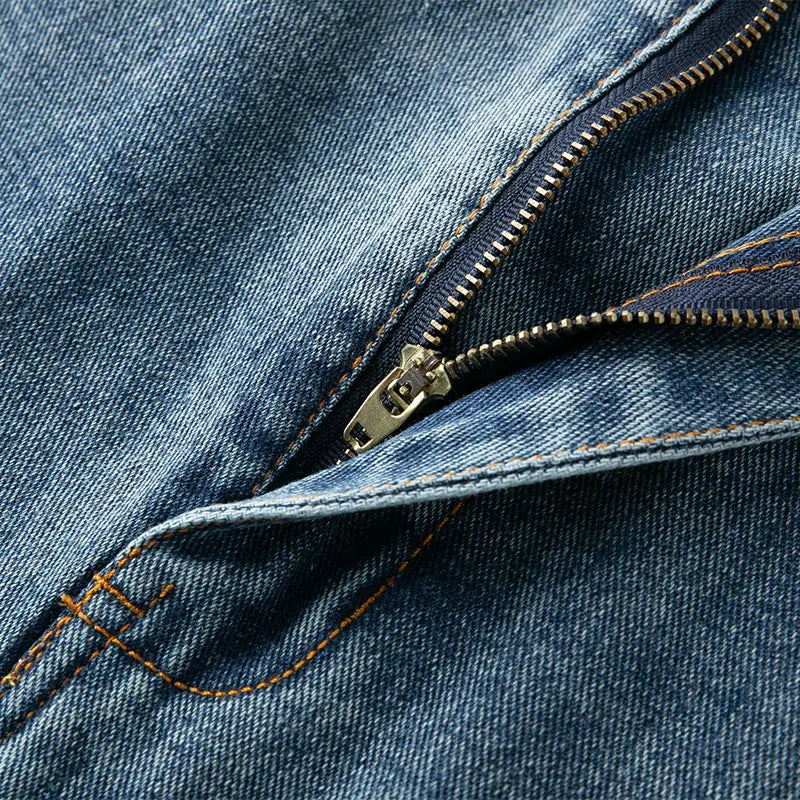 Close-up of a blue denim jacket with a zipper