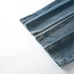 Folded blue denim jeans on a white background
