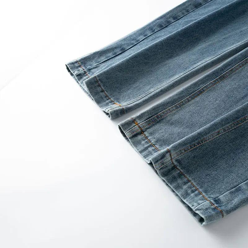 Folded blue denim jeans on a white background