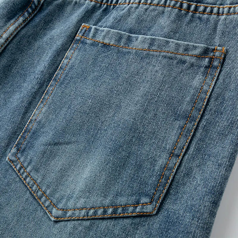 Close-up of a blue denim pocket with stitching details