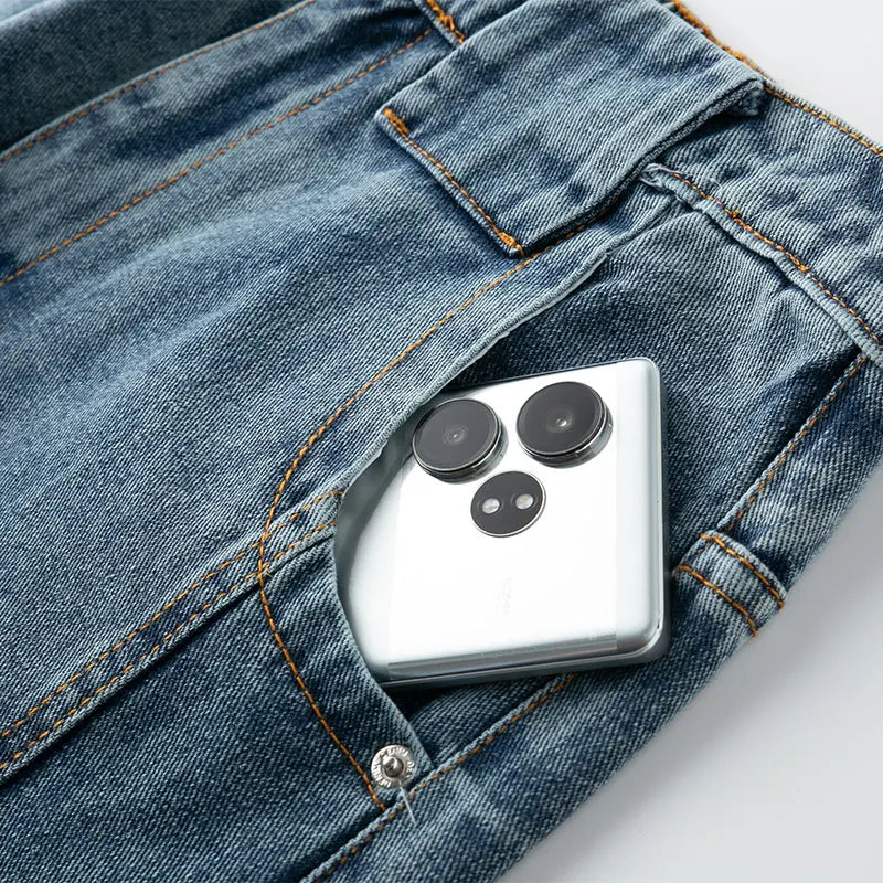 Smartphone with a unique camera design in a pocket of blue jeans