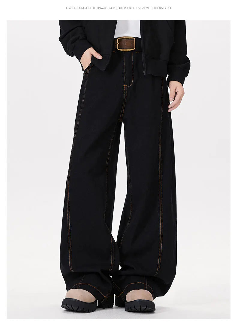 Person wearing black wide-leg pants on a white background