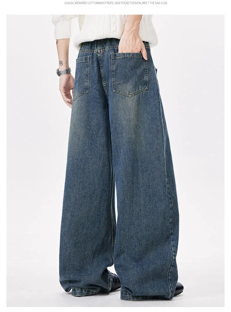 Person wearing wide-leg jeans on a white background