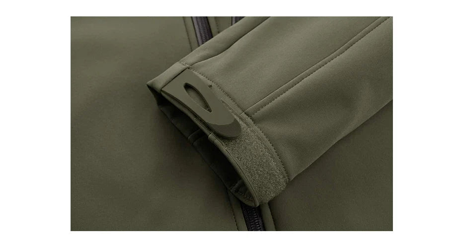 Close-up of a green jacket's sleeve with a button on a white background