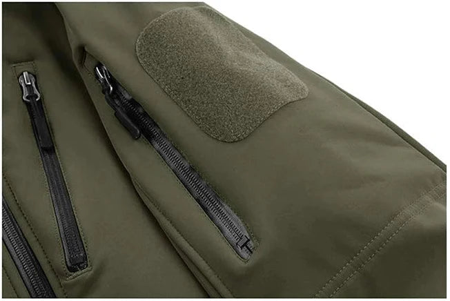 Close-up of a green tactical backpack with zippers and a patch on a white background