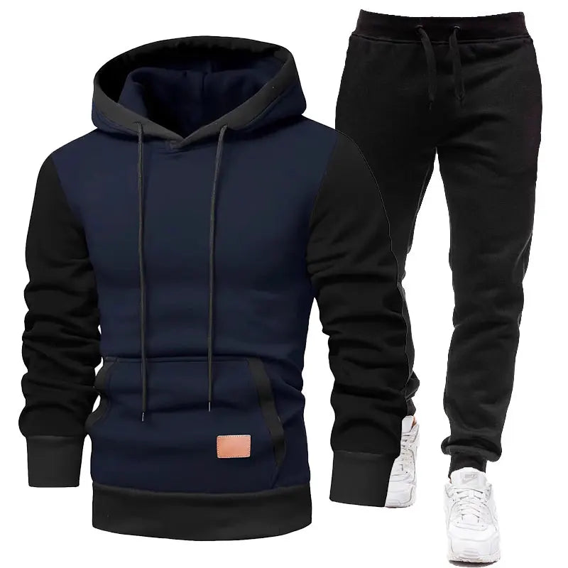 Navy and black hoodie and pants set with white sneakers on a white background