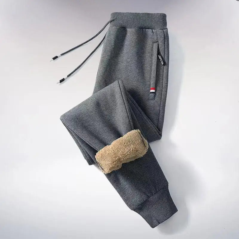 Gray fleece pants with beige patch on a light gray background