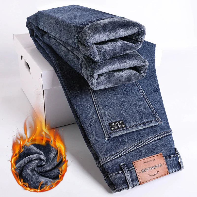 Folded blue jeans with a brand label on a white background
