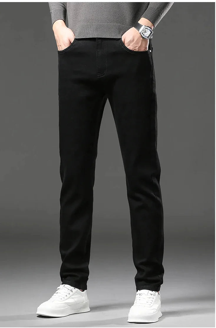 Person wearing black pants and white shoes on a gray background