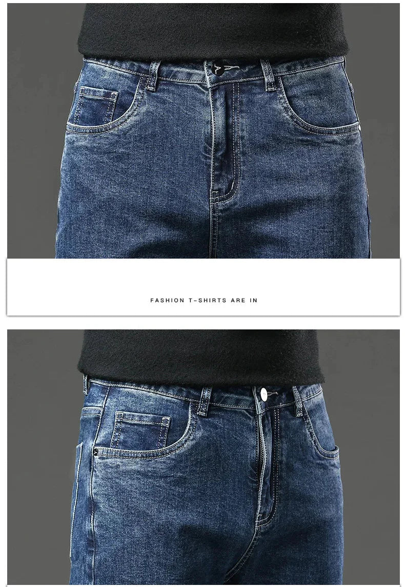 Close-up of blue jeans with a black shirt underneath on a gray background