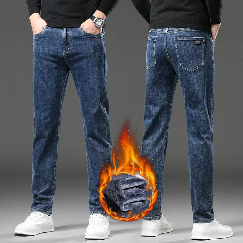 Person wearing blue jeans with a fiery graphic at the bottom on a gray background