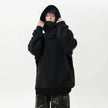 Person wearing a black hoodie on a white background