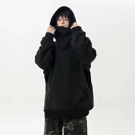 Person wearing a black hoodie on a white background