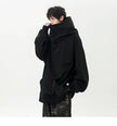Person wearing a black oversized hoodie on a white background
