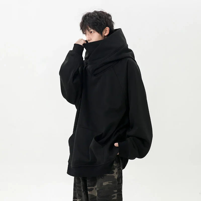 Person wearing a black oversized hoodie on a white background