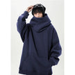 Person wearing a navy blue hoodie on a white background