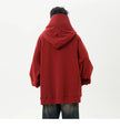 Person wearing a red hoodie from behind on a white background