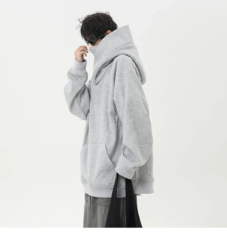 Person wearing a gray hoodie on a white background