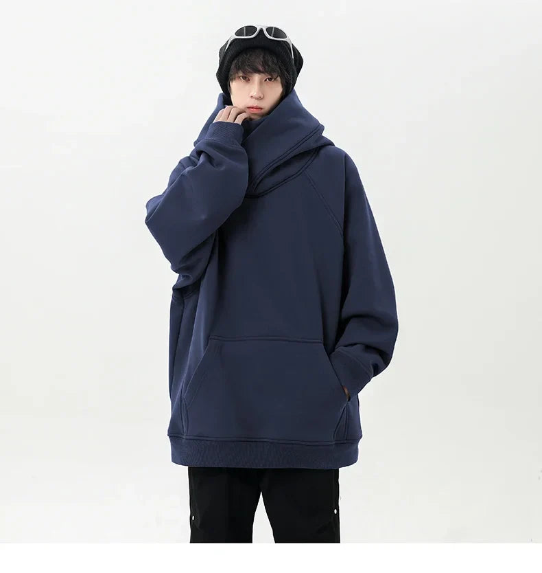 Person wearing a navy blue hoodie on a white background