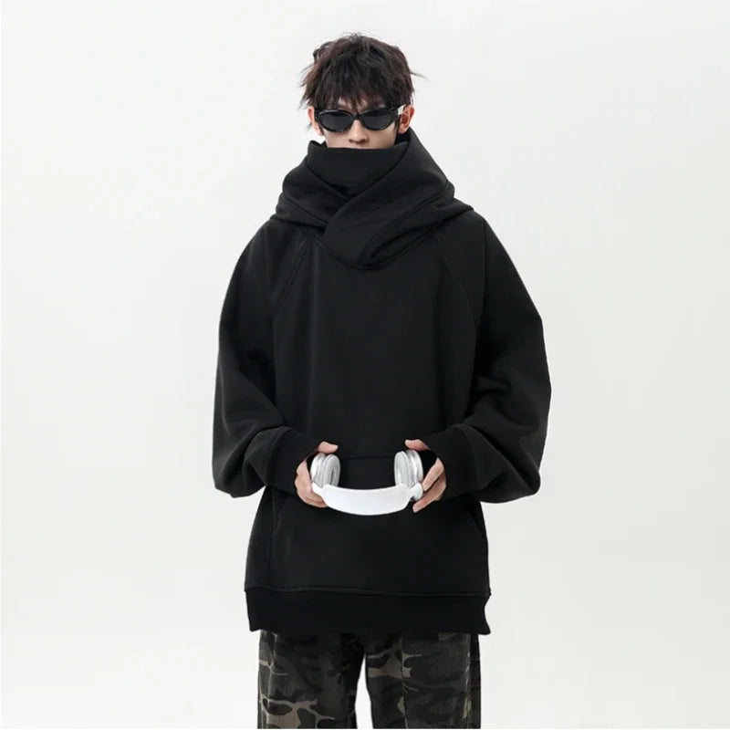 Person wearing a black oversized hoodie on a white background