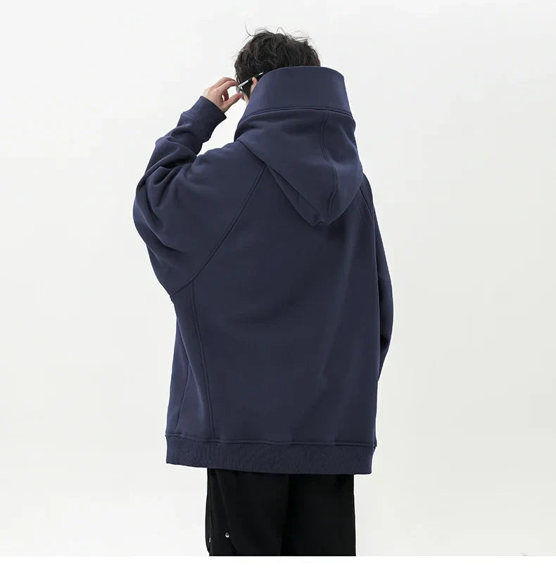 Person wearing a navy blue hoodie from behind on a white background