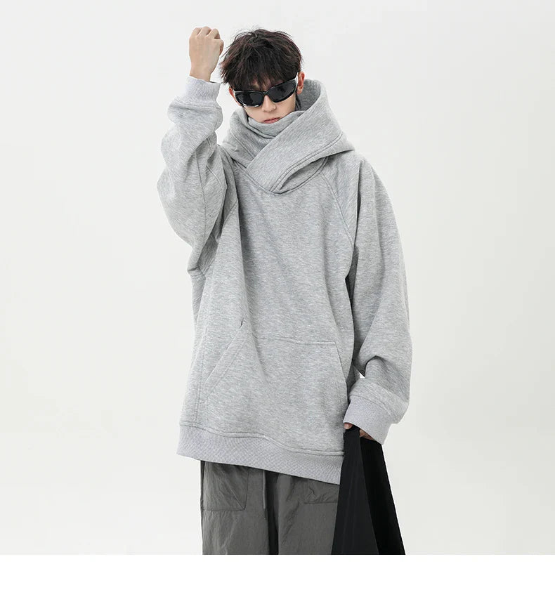 Person wearing a large gray hoodie on a white background