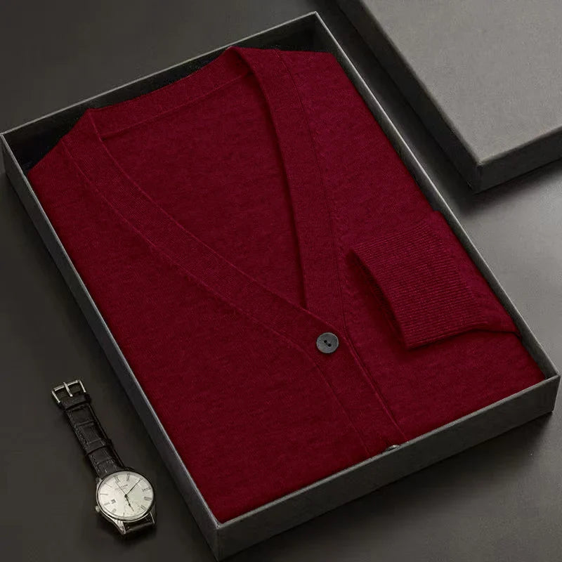 Red jacket in a black box with a watch on a dark surface