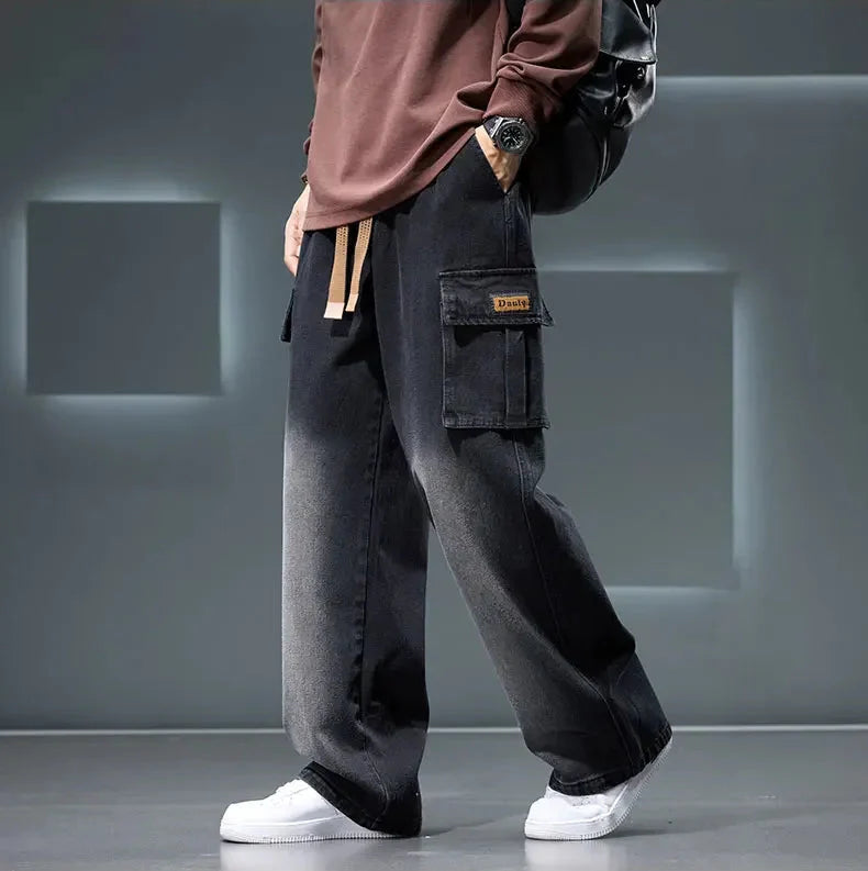 Person wearing black cargo pants with a gray background